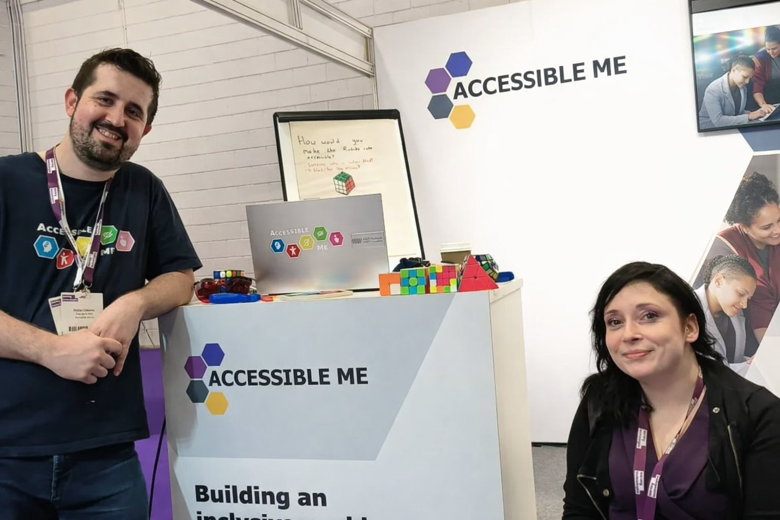 The AccessibleMe team at an industry event, standing at the AccessibleMe exhibition stand